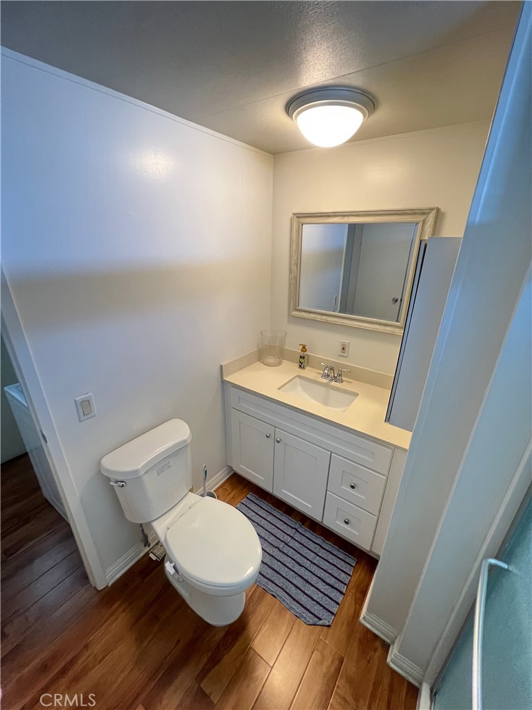 1010 Terrace Road, Unit 38 San Bernardino, CA 92410 - Photo 8 of 16 a bathroom with a sink mirror vanity and toilet
