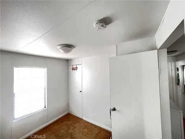 a view of kitchen with white cabinets and wooden floor