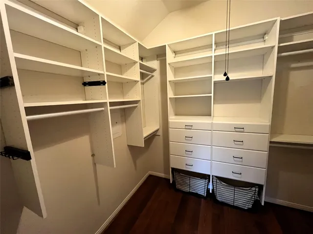a view of walk in closet with empty racks