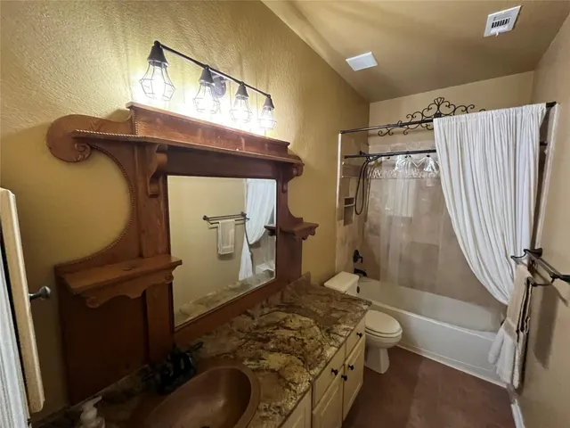 a bedroom with a bed and a mirror