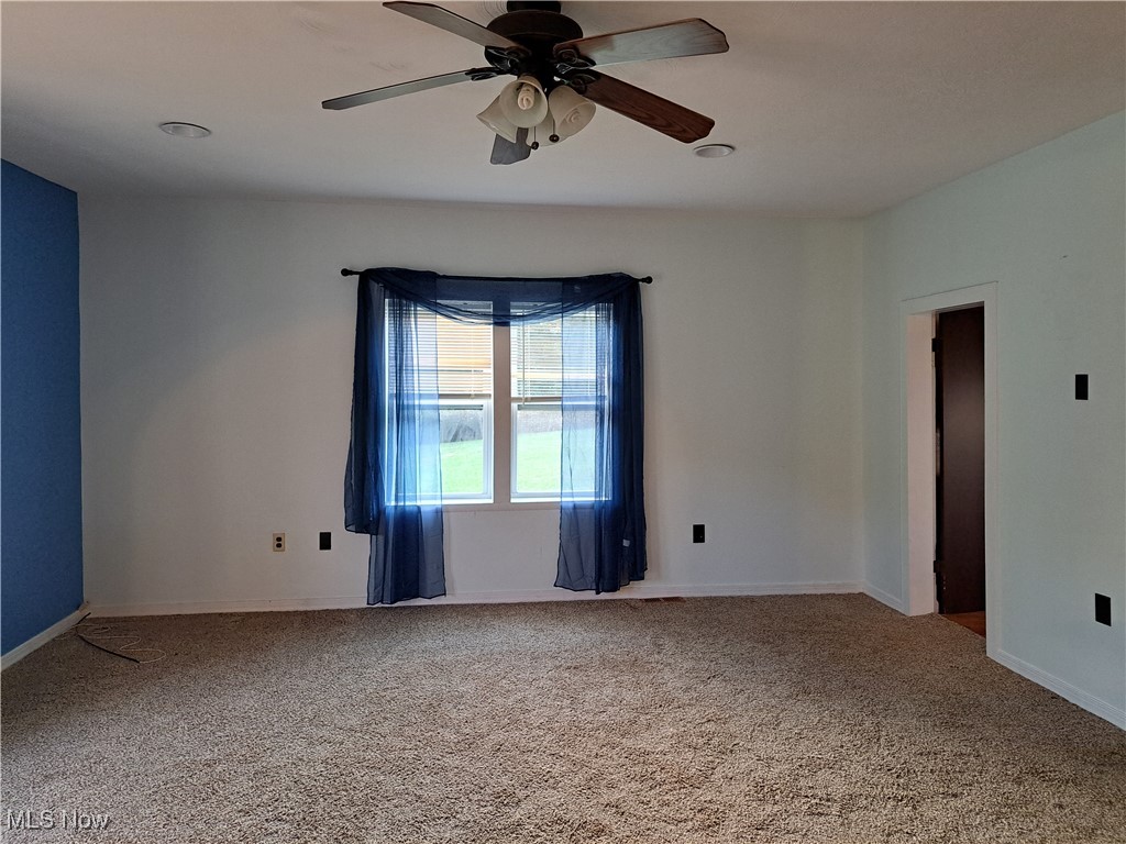 49197 John Tomcho Road Cumberland, OH 43732 - Photo 14 of 50 Carpeted family room featuring ceiling fan