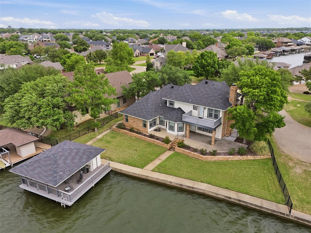 an aerial view of a house with a garden and lake view