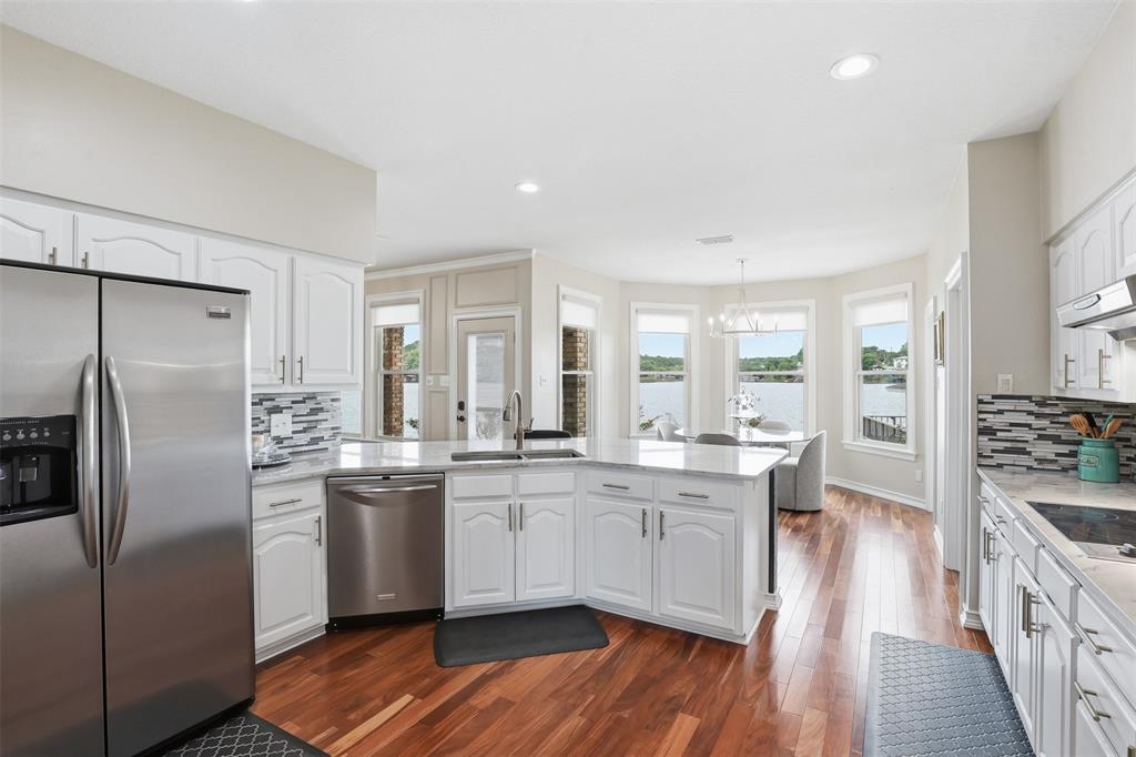 2406 River Road Granbury, TX 76048 - Photo 12 of 40 a kitchen with stainless steel appliances a sink stove and refrigerator