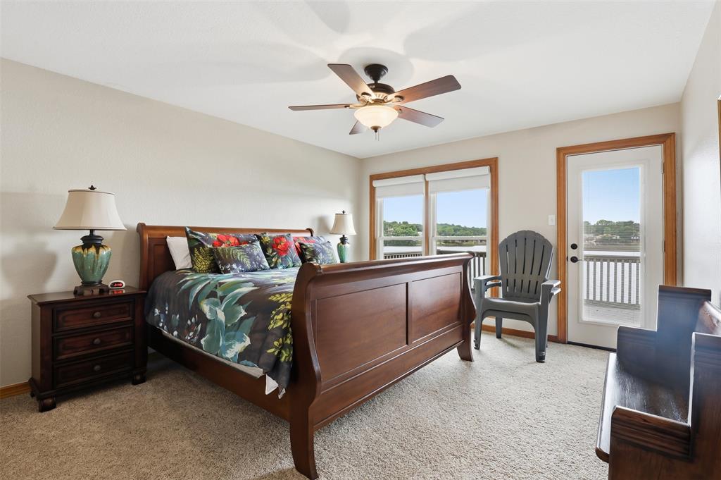 2406 River Road Granbury, TX 76048 - Photo 20 of 40 a bedroom with a bed and a large window