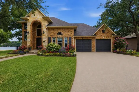 front view of a house with a yard and an trees