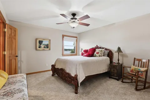 a spacious bedroom with a bed and a chandelier