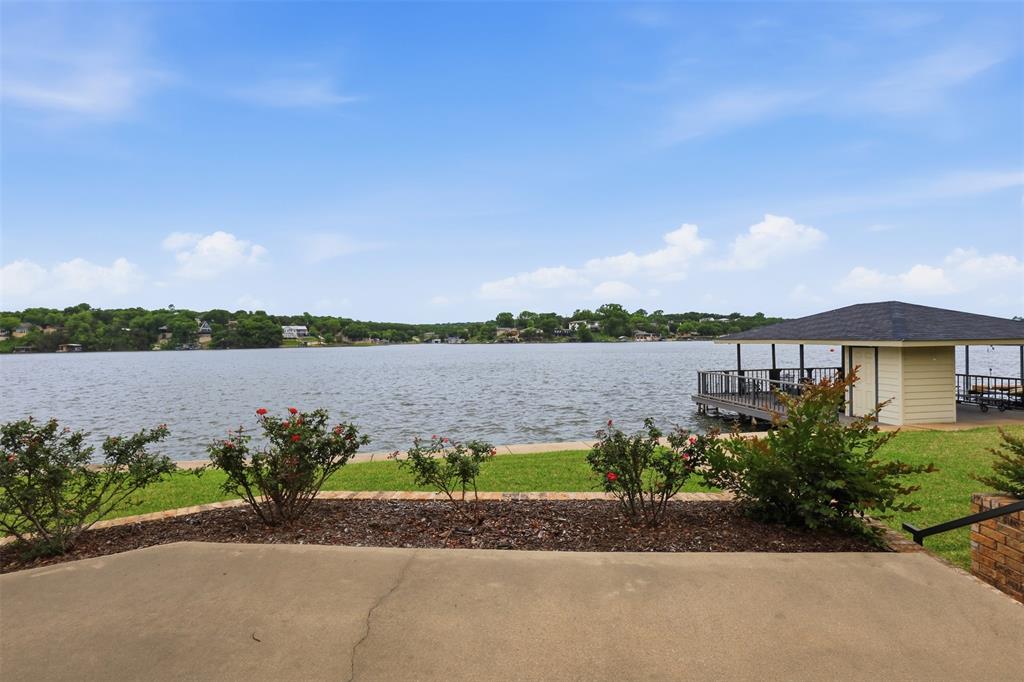 2406 River Road Granbury, TX 76048 - Photo 28 of 40 a lake view with a garden