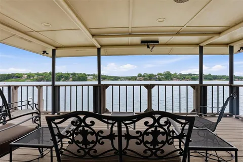a view of a chairs and table in the balcony