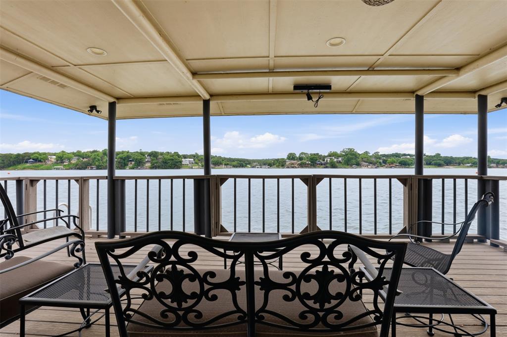 2406 River Road Granbury, TX 76048 - Photo 32 of 40 a view of a chairs and table in the balcony
