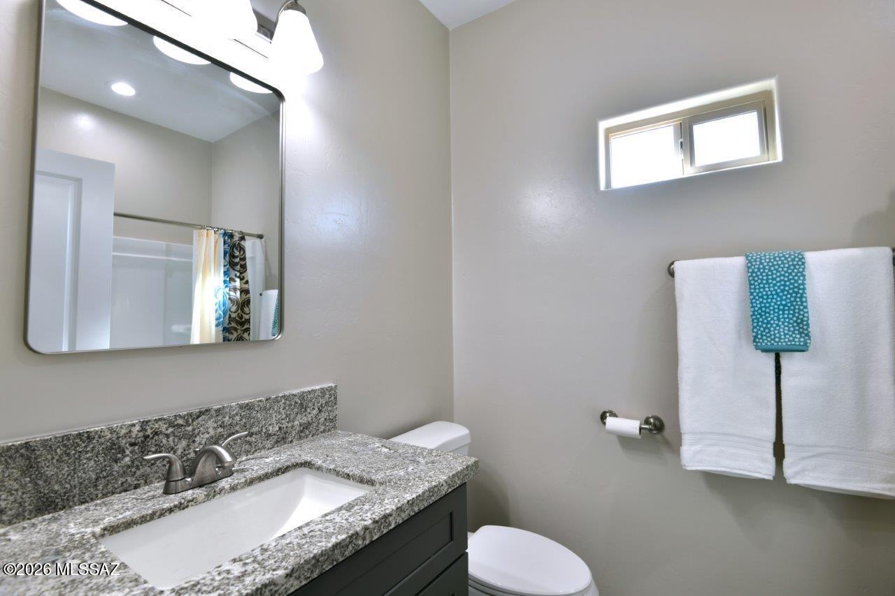 1091 North Vail View Road Vail, AZ 85641 - Photo 30 of 43 a bathroom with a granite countertop sink and a mirror