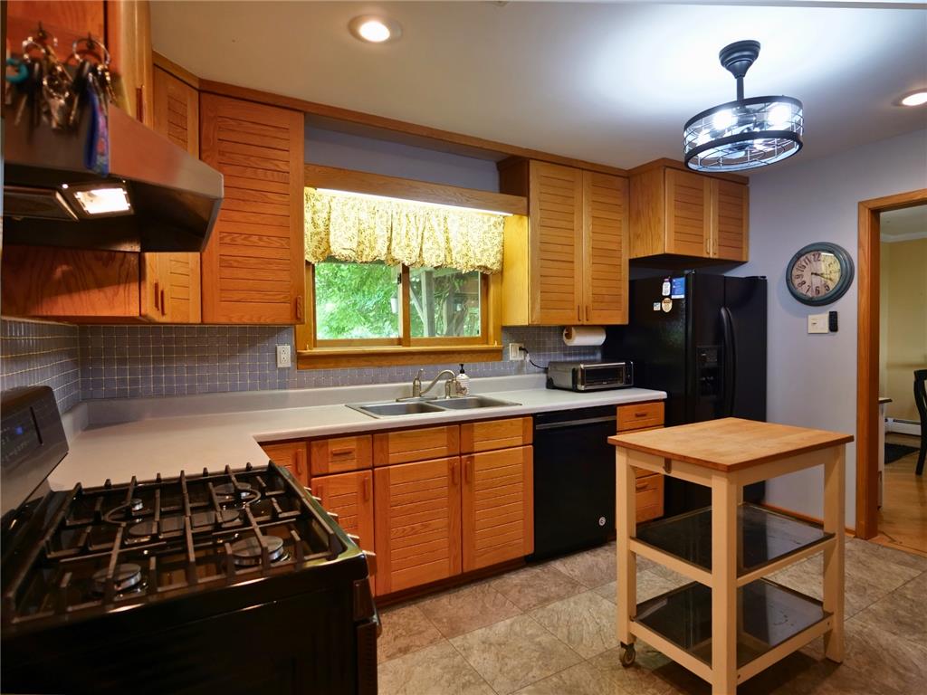 2233 Aster Road Macungie, PA 18062 - Photo 9 of 30 a kitchen with stainless steel appliances granite countertop a sink stove and refrigerator
