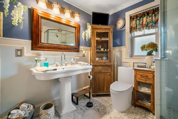 a bathroom with a toilet sink and mirror
