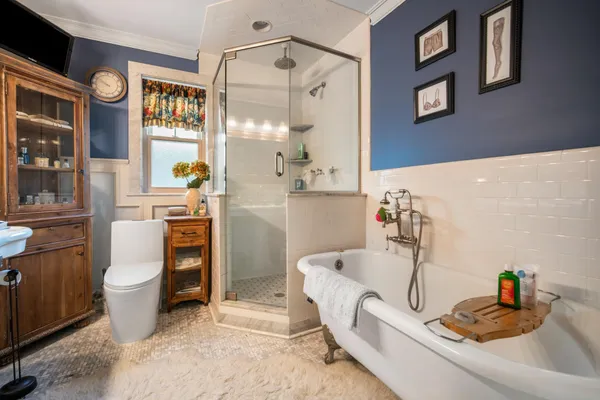 a spacious bedroom with a bed and a flat screen tv
