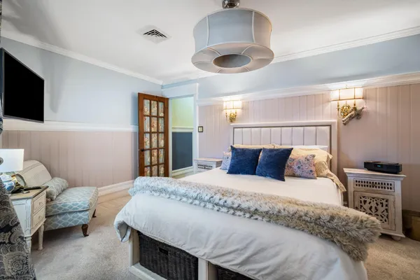 a bedroom with a bed and a large window