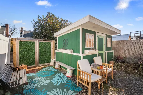 a view of a patio with a table and chairs