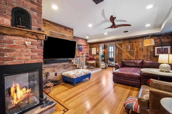 a living room with furniture fireplace and flat screen tv