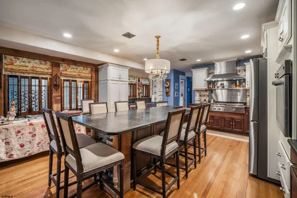 a dining room with furniture and wooden floor