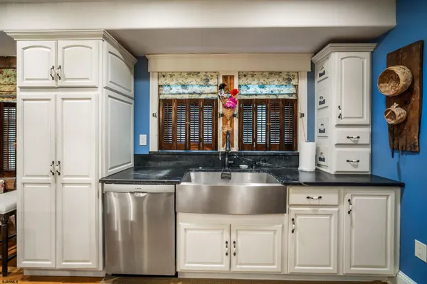 a kitchen with cabinets and window