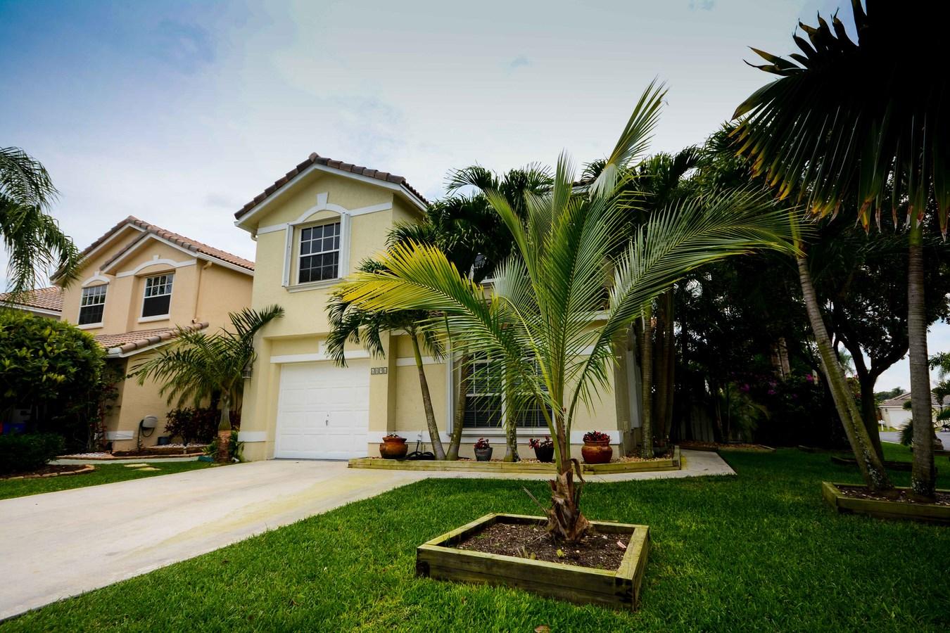 6896 Long Key Street Lake Worth, FL 33467 - Photo 1 of 18 a front view of house with yard and green space