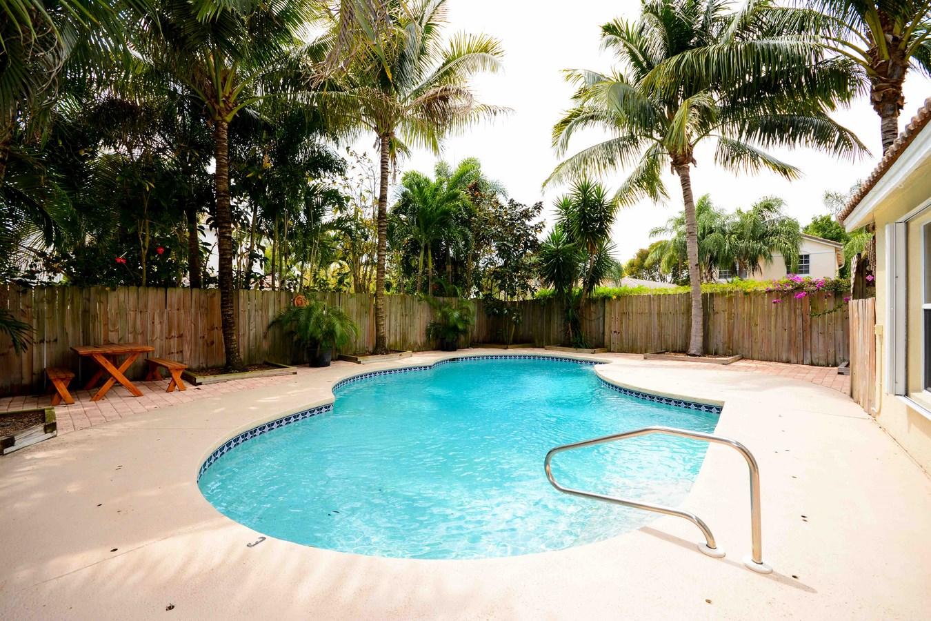 6896 Long Key Street Lake Worth, FL 33467 - Photo 16 of 18 a view of a backyard with a slide
