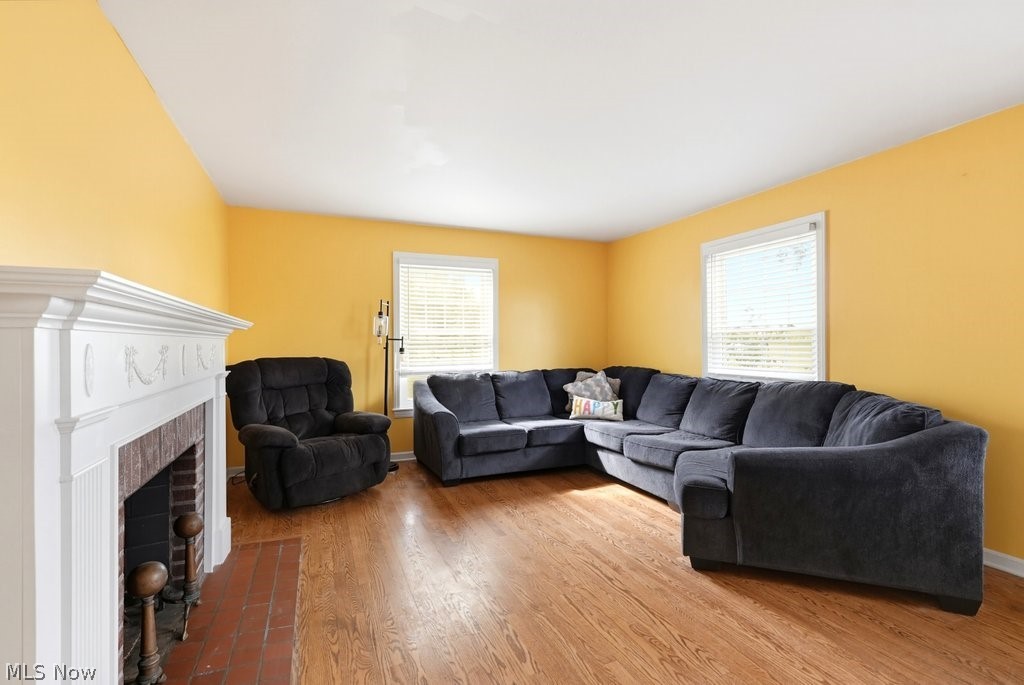 149 North Medina Line Road Akron, OH 44333 - Photo 12 of 42 Hardwood flooring, white window frames, and a brick-faced fireplace with a white mantel