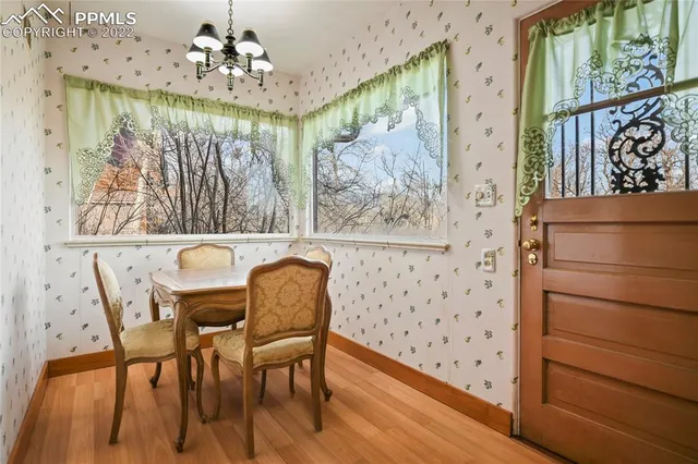 a view of a dining room with furniture and chandelier