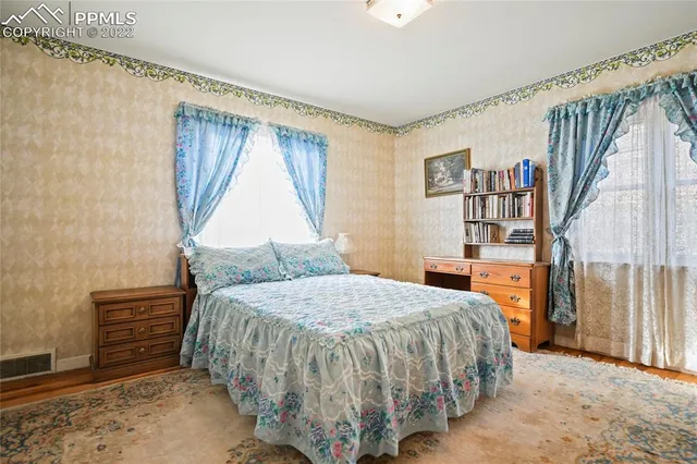 a bedroom with a bed and a book shelf