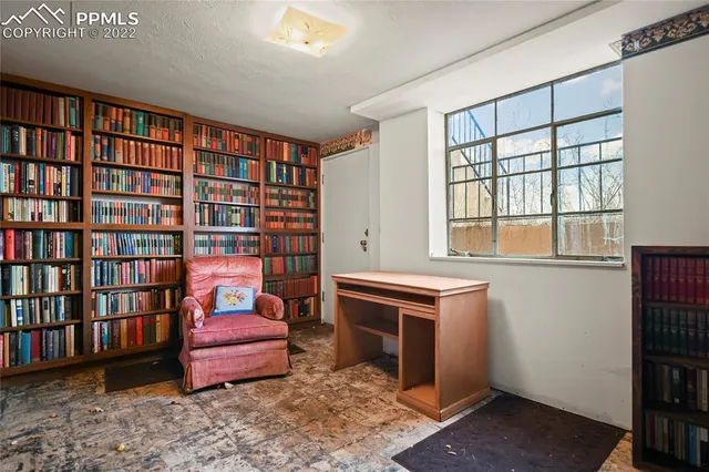 a living room with fireplace furniture and a book shelf