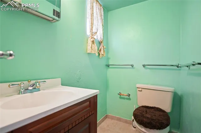 a bathroom with a sink a toilet and a mirror