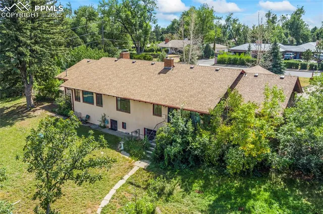 an aerial view of a house with a yard table and chairs