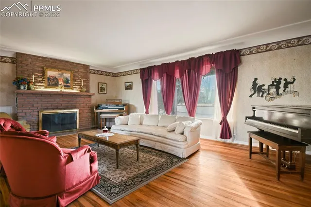 a living room with furniture a fireplace and a table