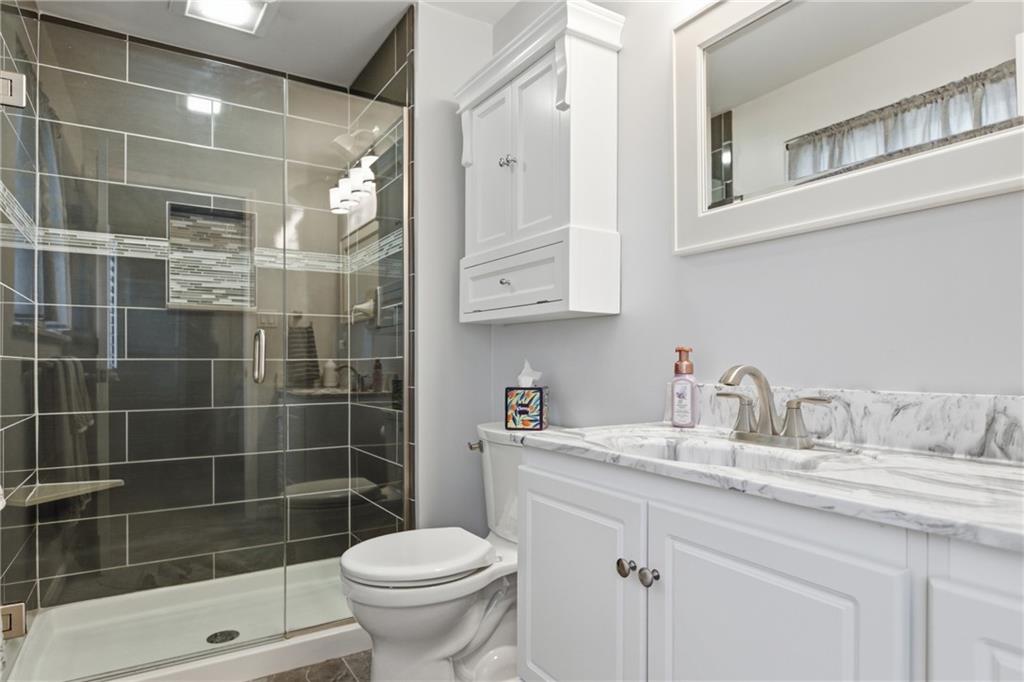 2955 Kings Mill Road Bethel Park, PA 15102 - Photo 14 of 40 a bathroom with a sink a toilet and shower