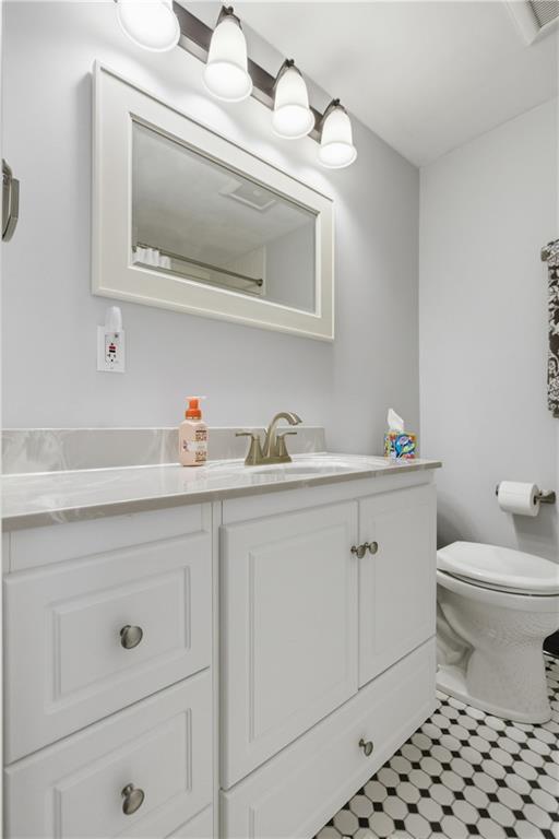2955 Kings Mill Road Bethel Park, PA 15102 - Photo 19 of 40 a bathroom with a sink a toilet and vanity
