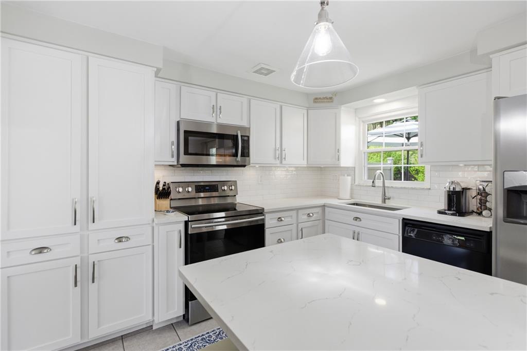 2955 Kings Mill Road Bethel Park, PA 15102 - Photo 8 of 40 a kitchen with a stove a sink and a microwave