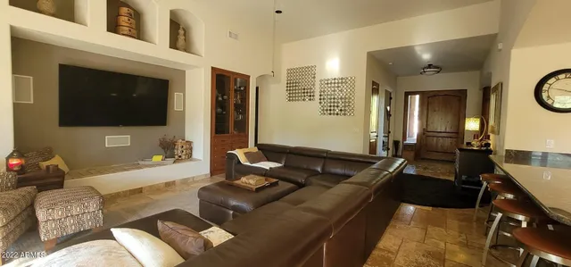 a living room with furniture a flat screen tv and a fireplace