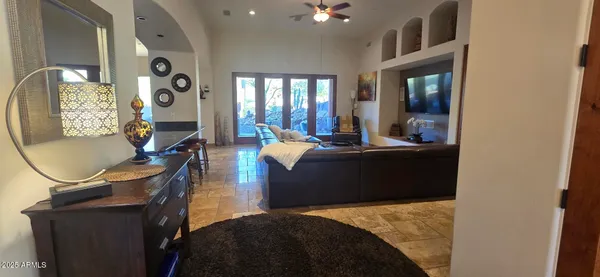 a living room with furniture a flat screen tv and a fireplace