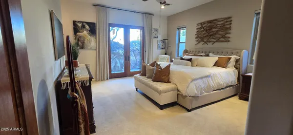 a bedroom with a bed couch and a window