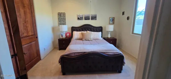 a bed sitting in a bedroom next to a window