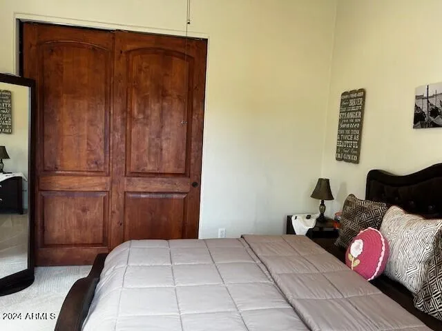a view of a patio with lawn chairs under an umbrella