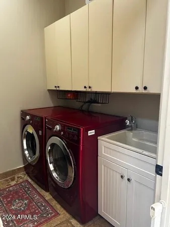 a bathroom with a sink and a washer dryer