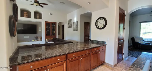 a view of a dining room with furniture a chandelier and wooden floor