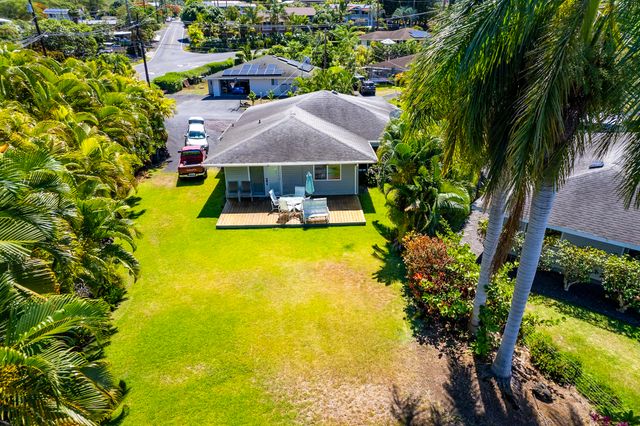 an aerial view of a house with swimming pool and garden