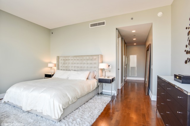 401 North Wabash Avenue, Unit 80B Chicago, IL 60611 - Photo 12 of 34 a bedroom with a bed and wooden floor