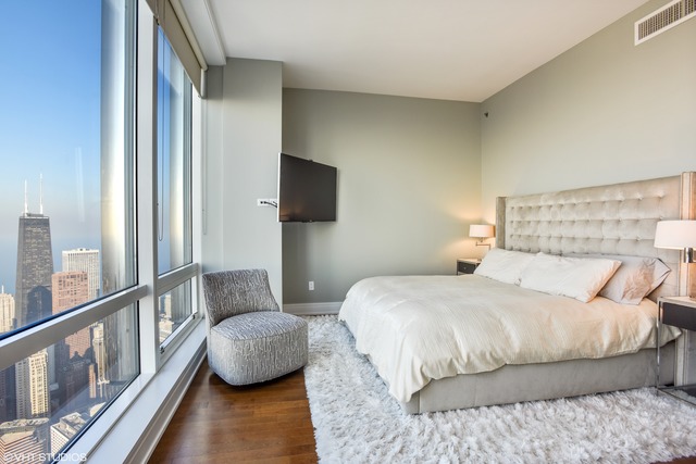 401 North Wabash Avenue, Unit 80B Chicago, IL 60611 - Photo 13 of 34 a bedroom with a bed and a flat screen tv