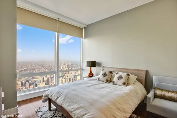 a bedroom with a large bed and a large window