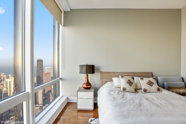 401 North Wabash Avenue, Unit 80B Chicago, IL 60611 - Photo 17 of 34 a bed sitting in a bedroom next to a window