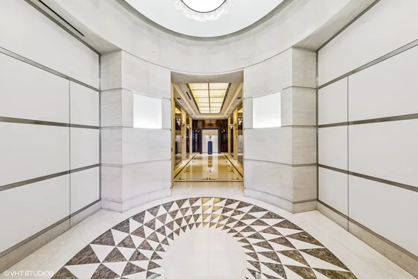 a view of a hallway with wooden floor and a dining table with wooden floor