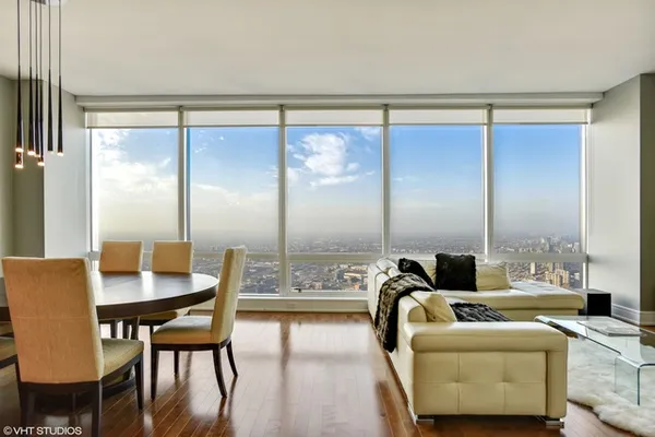 a dining room with furniture and a large window