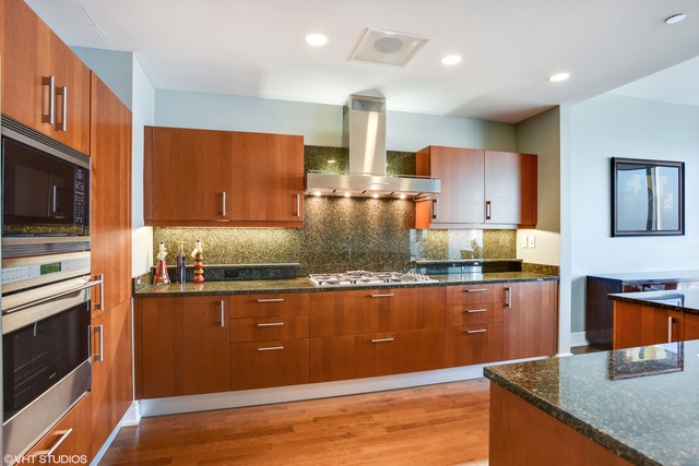 401 North Wabash Avenue, Unit 80B Chicago, IL 60611 - Photo 8 of 34 a kitchen with stainless steel appliances granite countertop a sink a stove and a microwave