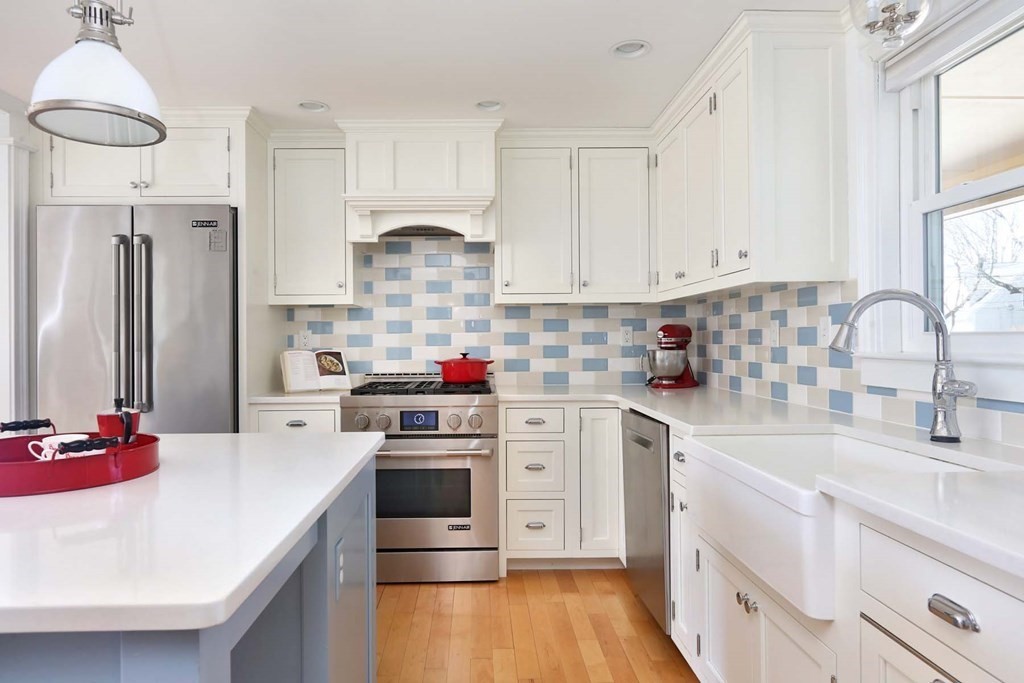 491 Webster Street Needham, MA 02494 - Photo 14 of 37 a kitchen with white cabinets and stainless steel appliances
